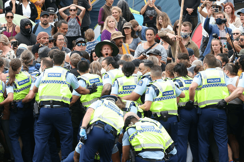 Protesters resist police after refusing to leave parliament grounds during the third day of demonstrations against Covid restrictions in Wellington on February 10, 2022 (Photo: MARTY MELVILLE/AFP via Getty Images) 
