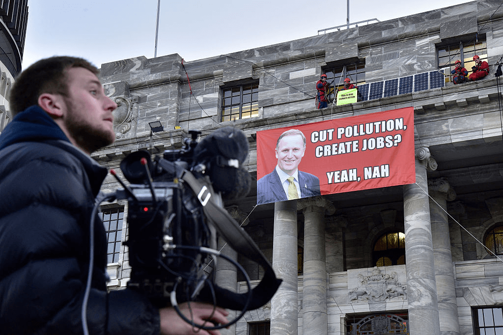 WELLINGTON, NEW ZEALAND - JUNE 25: Media wait for Greenpeace activists to absail back down from the roof at Parliament House on June 25, 2015 in Wellington, New Zealand. Four Greenpeace activists breached security and scaled the walls of Parliament House to protest the government's record on climate change. (Photo by Marty Melville/Getty Images)