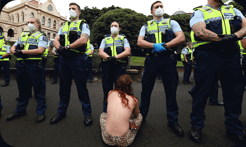 A woman sits in front of police before they moved in to evict protesters in parliament grounds, February 10, 2022 (Photo by MARTY MELVILLE/AFP via Getty Images; additional design by Tina Tiller)