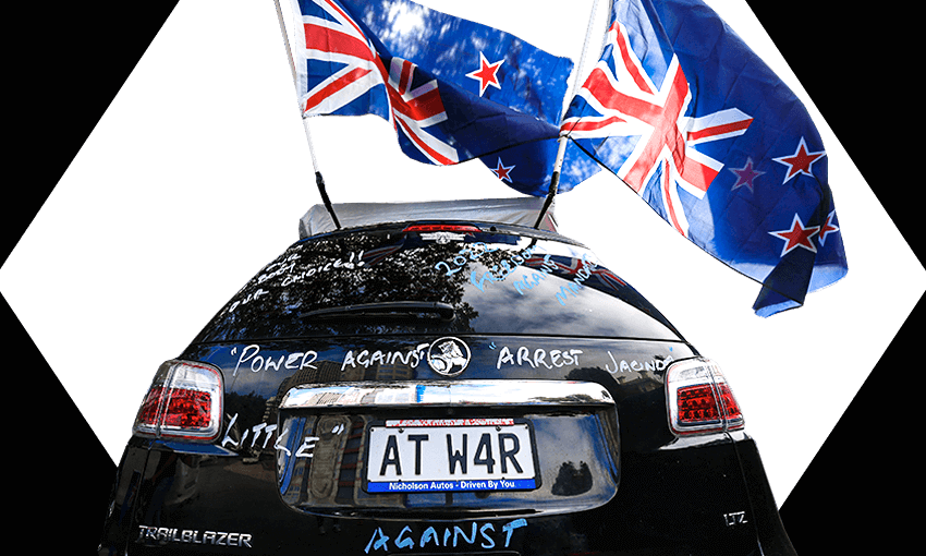 Car parked near parliament in Wellington decorated with upside down flags and a number plate saying "At War"