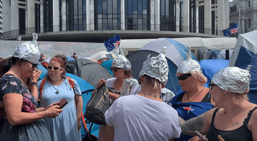 Parliament protesters wearing tinfoil hats