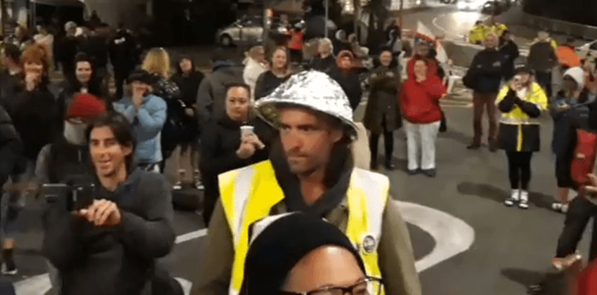Wellington protest with foil wrapped helmet