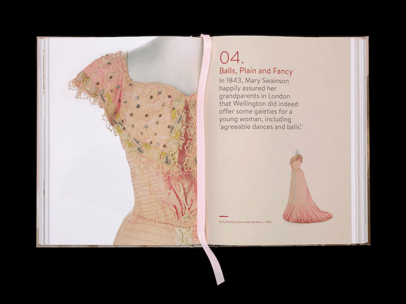 Photo of an open book, left page taken up with beautiful photograph of a dusky rose ballgown with little cap sleeves. Right page is a short piece of text about Wellington parties in the 1800s.