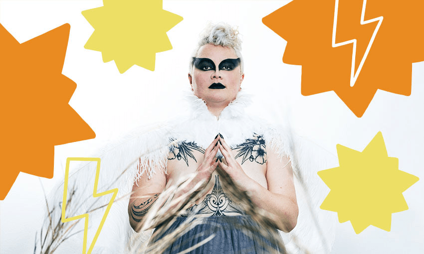 Photo of a woman dressed magnificently in dramatic black makeup and feathered costume.