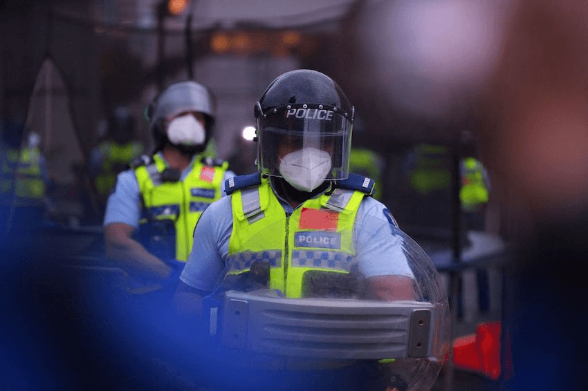 Police hold riot shields agains protesters on the final day of the parliament occupation on March 2, 2022 (Photo: DAVE LINTOTT/AFP via Getty Images) 
