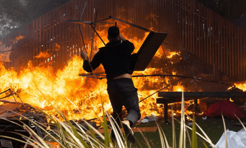 A rioter throws a desk on to a fire by the parliamentary playground at the end of the parliament occupation, March 2, 2022. (Photo: Marty Melville / AFP via Getty Images) 
