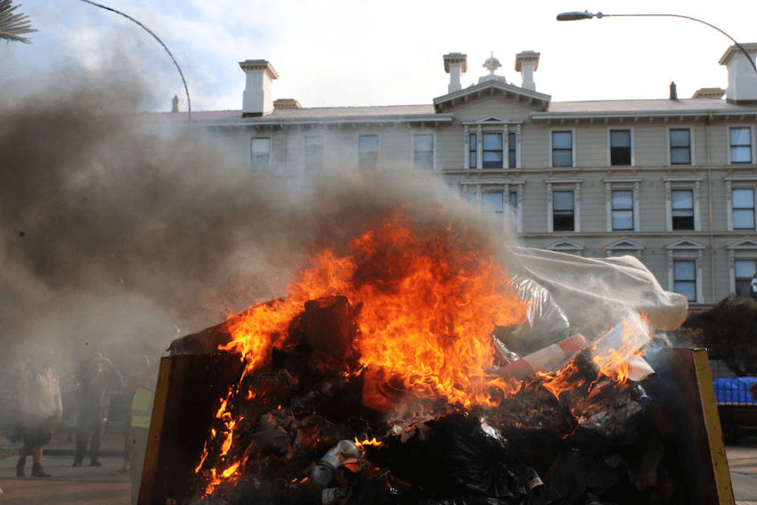 A fire burns in a rubbish skip outside the law school near parliament. (Photo: Lynn Grieveson/Getty Images) 

