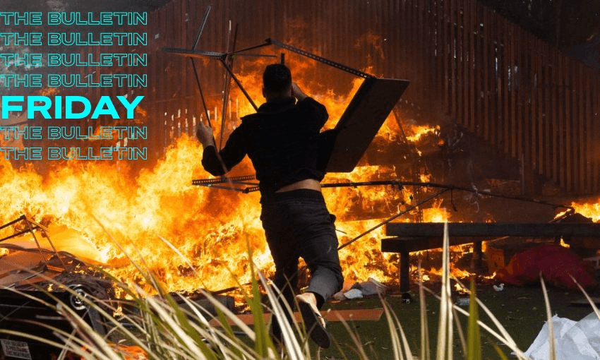 A rioter throws a desk on to a fire by the parliamentary playground. (Marty Melville / AFP via Getty Images)