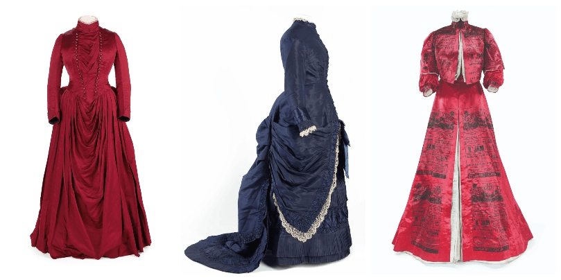 Three dresses from the 1800s, photographed on mannequins, two deep red and one a lovely navy blue. 