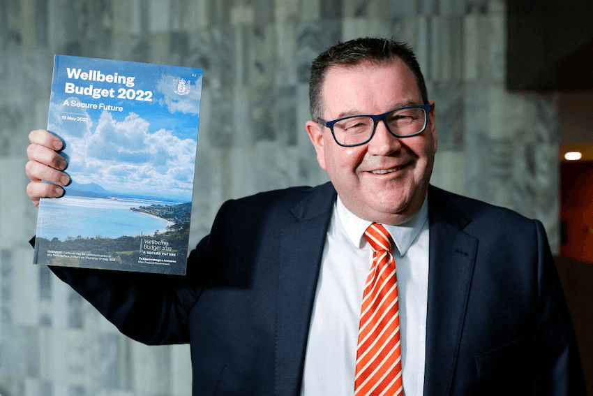 WELLINGTON, NEW ZEALAND – MAY 17: Finance Minister Grant Robertson poses with a copy of the Wellbeing Budget 2022 during a photo opportunity at Parliament on May 17, 2022 in Wellington, New Zealand. Finance Minister Grant Robertson will deliver Budget 2022 on Thursday 19 May, 2022. (Photo by Hagen Hopkins/Getty Images) 
