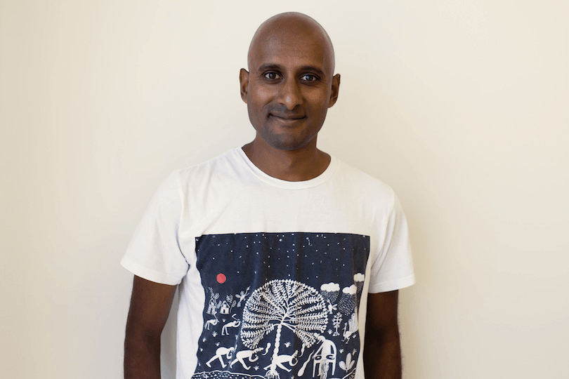 Photograph of middle-aged man wearing white printed T. 