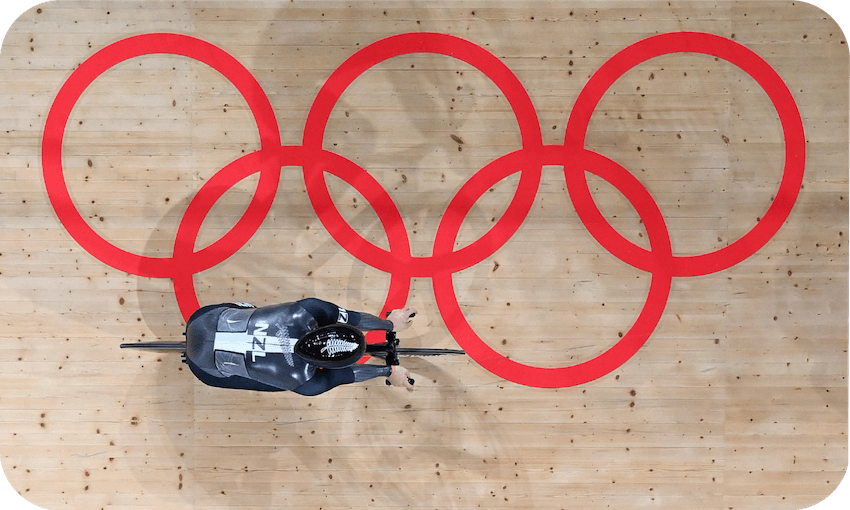 overhead view of a cyclist on a track printed with the Olympic rings