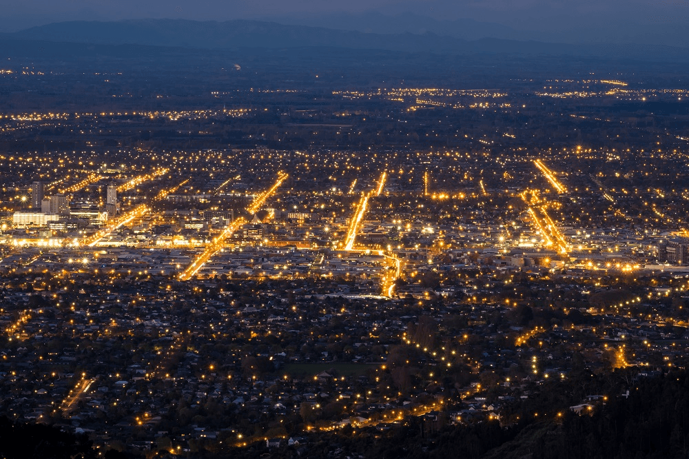 lines of light show the location of streets. hazy dark sky and light pollution