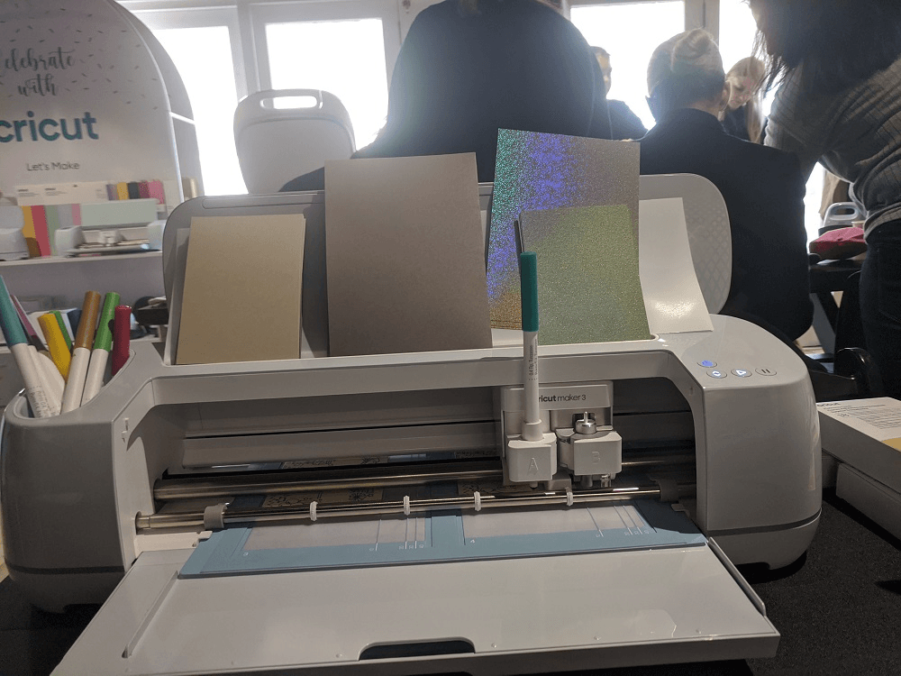 plastic machine with shiny paper is drawing on a piece of cardstock