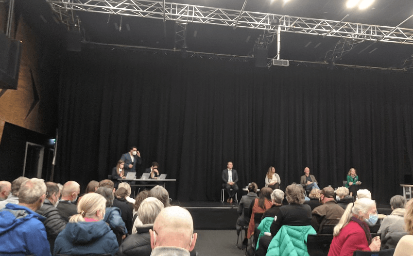 four candidates in a high school auditorium