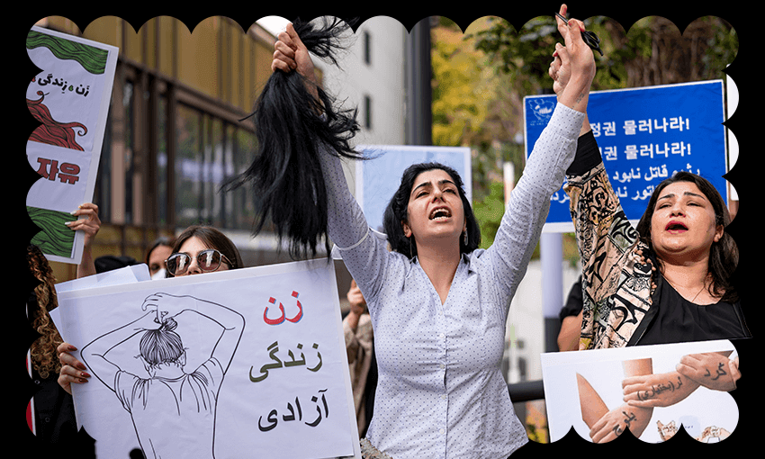 A member of the Iranian community in Seoul cuts her hair outside the Embassy of the Islamic Republic of Iran (Photo by Chris Jung/NurPhoto via Getty Images) 
