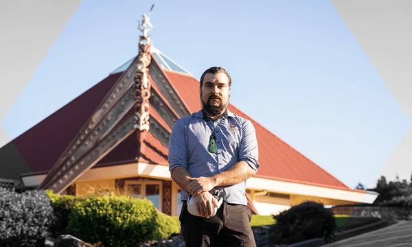 Rory Clifford stands outside Te Rau Aroha marae (Image: Maija Stephens) 
