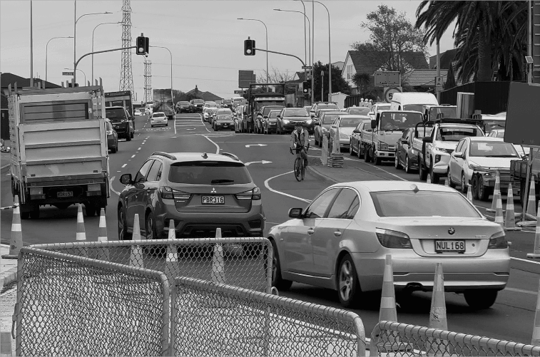 Cyclist crossing busy traffic