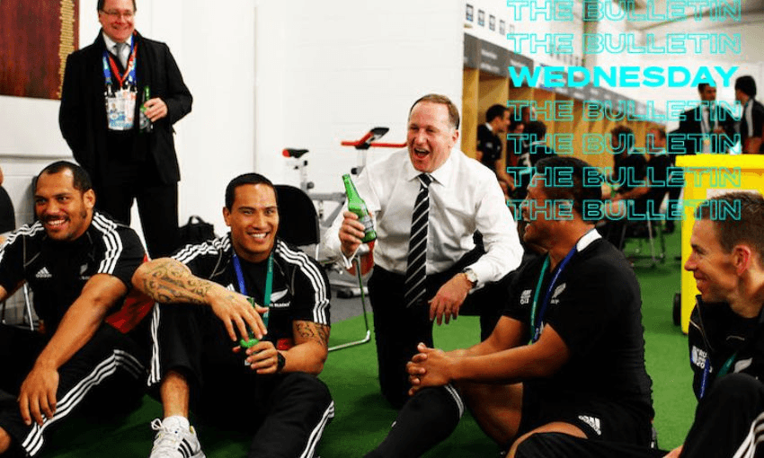John Key celebrates with a beer and the All Blacks in 2011 after their win over France, a country that banned alcohol advertising on television in 1991 (Image: Getty) 
