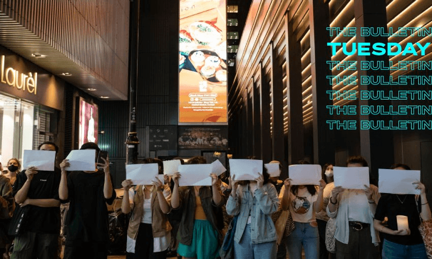 People hold sheets of paper in protest of Covid restrictions during a vigil in the central district in Hong Kong, China. (Photo by Anthony Kwan/Getty Images) 
