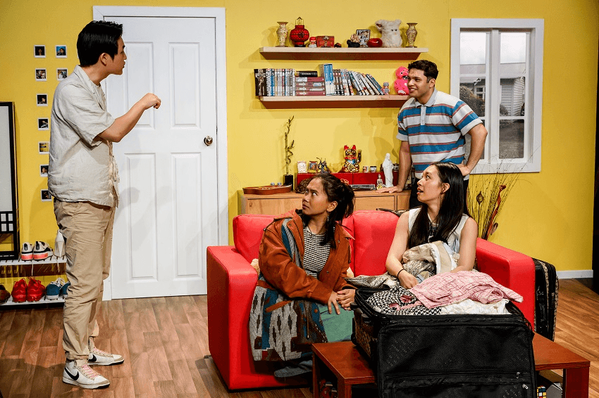 yellow wall and door and couch with four asian actors talking to each other
