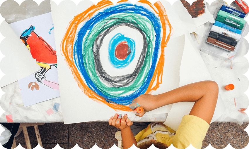 a wavy border around a top-down photo of a kid drawing