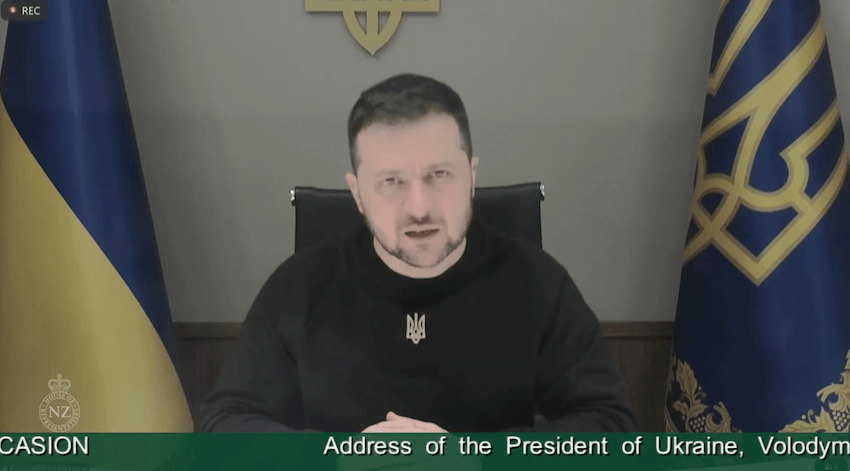 A man in a dark shirt with the parliament tickertape beneath the screenshot