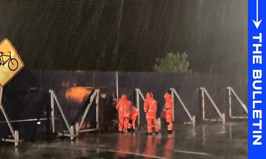 A team erect a stoplog early this morning to provide addtional protection as the Ohinemuri River rises in Hauraki (Image: Waikato District Council) 
