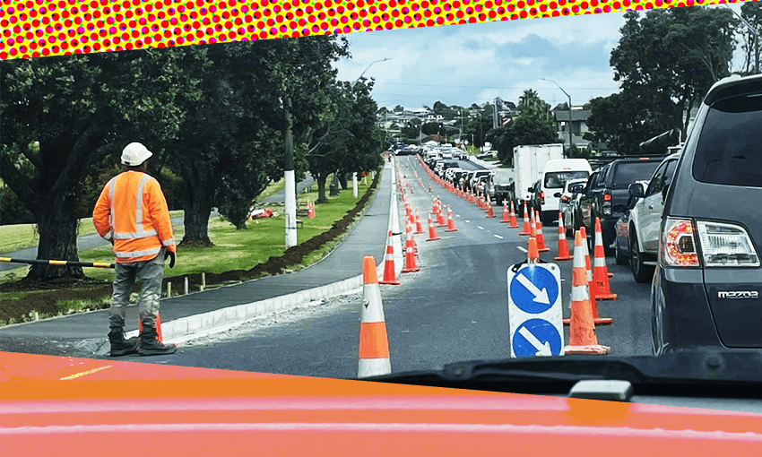 an orange border around a line of traffic skirting around some orange cones