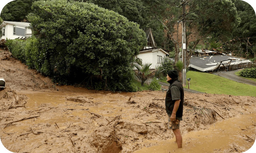A resident wades through a large landslide on Domain Crescent in Muriwai following Cyclone Gabrielle, February 14, 2023. (Photo: Phil Walter/Getty Images) 
