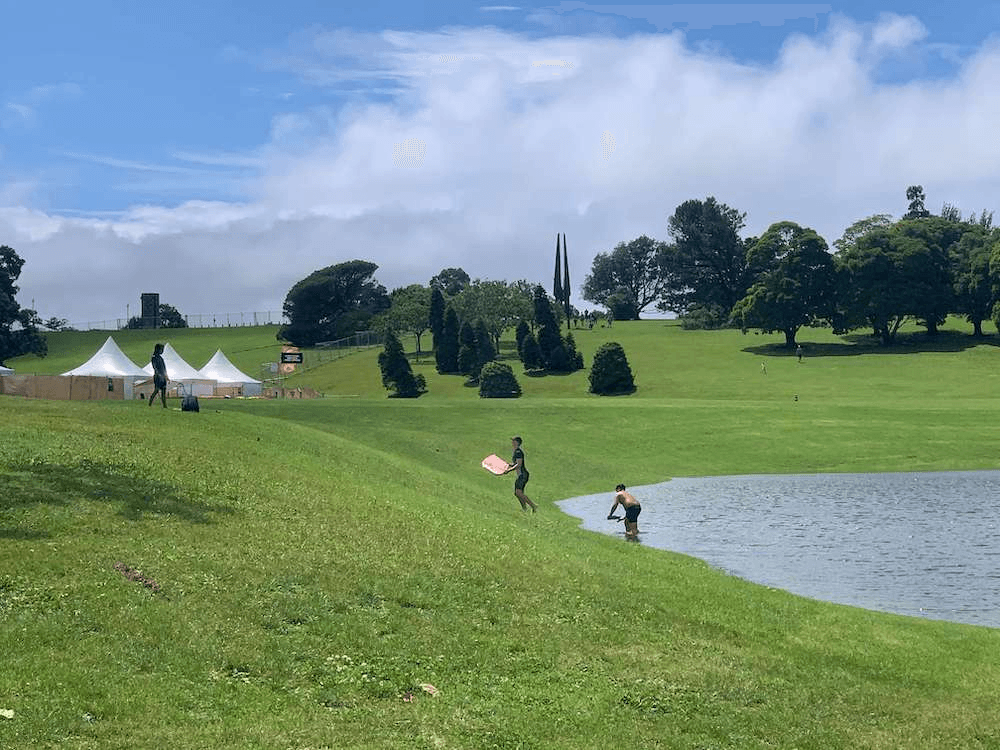 Children boogie boarding at the flooded Auckland Domain.