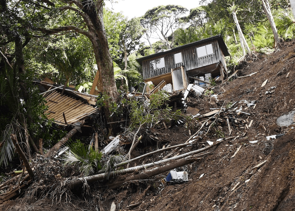 Damage to homes on Lone Kauri Road in Karekare. (Photo: Ted Scott) 
