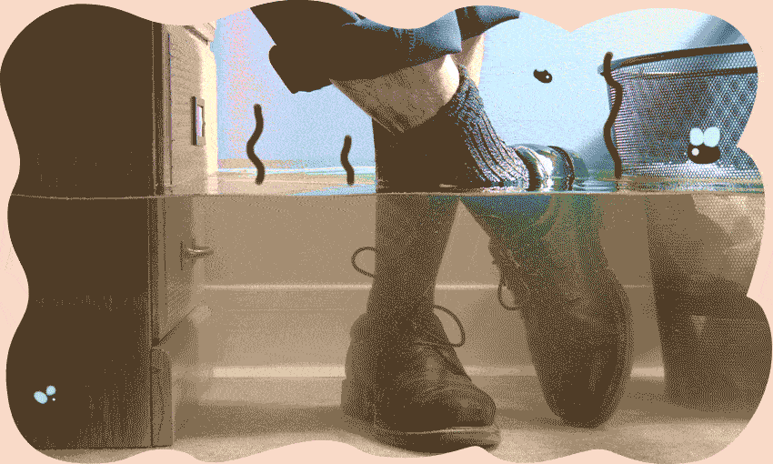 a pair of shoes submerged by floodwater with flies buzzing around