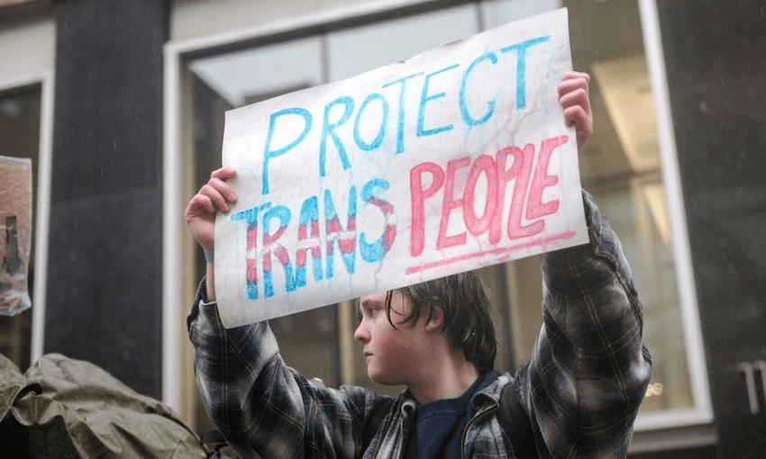A person holds a sign advocating for trans rights (Photo by ANDREJ IVANOV/AFP via Getty Images) 
