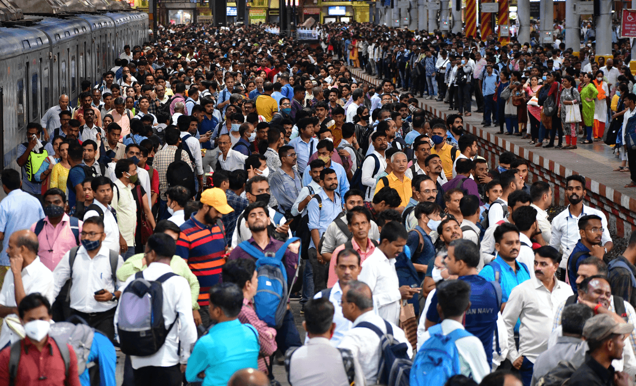 a massive crowd of commuters waiting for a train in Mumbai