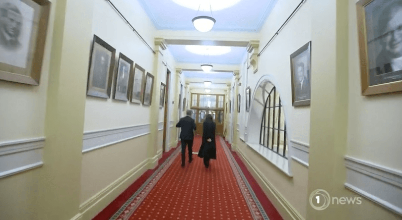 John Campbell and Jacinda Ardern walk through parliament