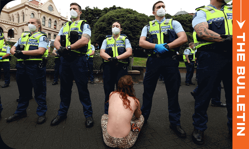 A parliament protestor sits in front of police, February 10, 2022. (Photo: Marty Melville/ Getty Images) 
