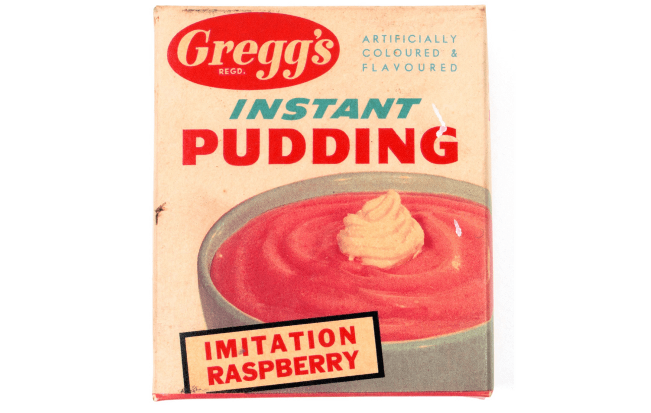 A retro package of Gregg's instant pudding in imitation raspberry flavour. A bowl of pink gloop with a dollop of cream takes up most of the package.