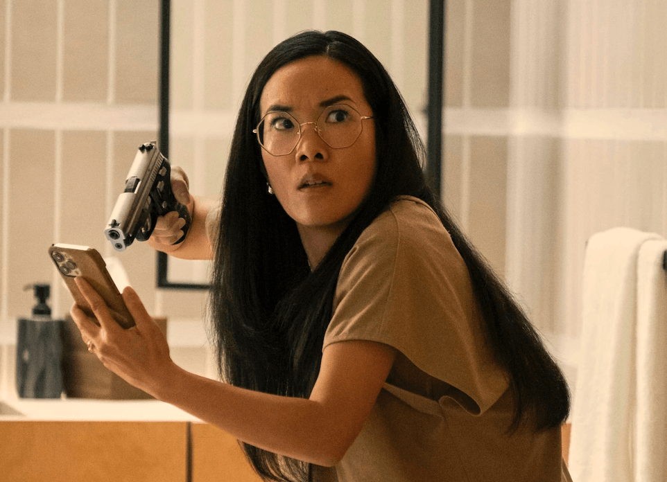 Ali Wong points a gun at her phone in Beef.