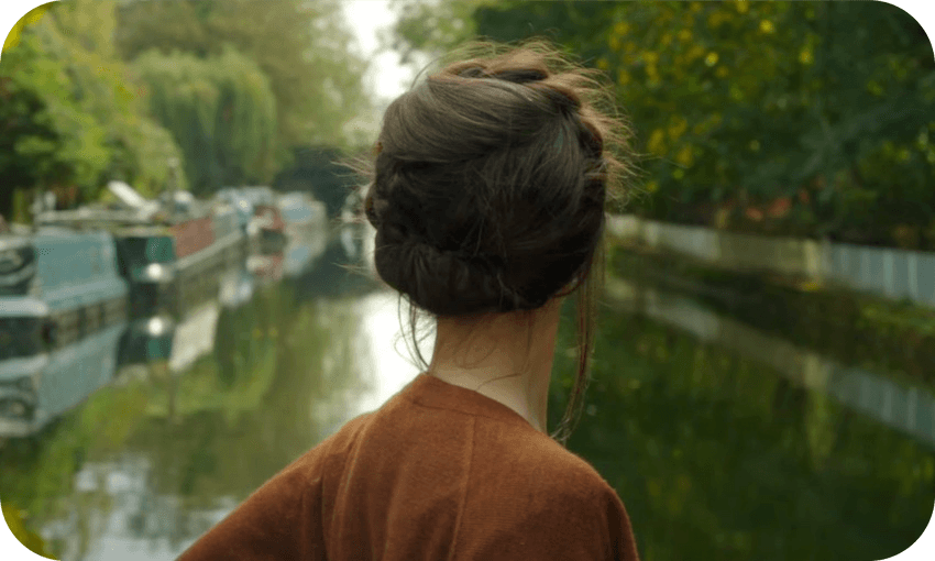 The back of a woman's head as she travels down a canal –A still from the trailer for Anchor and Hope, a movie about lesbians living on a houseboat