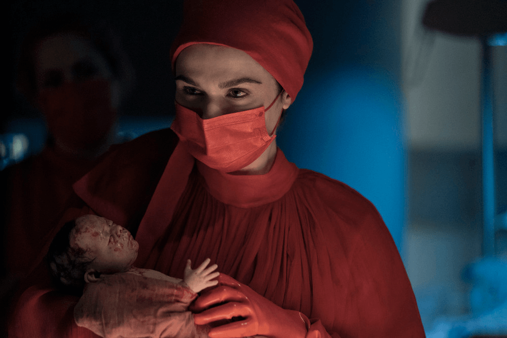 Rachel Weisz holds a baby in the Amazon Prime show Dead Ringers.
