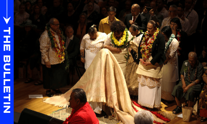 Prime minister Jacinda Ardern sits under a fine mat as part of the official dawn raids apology, August 2021 (Photo: Justin Latif) 
