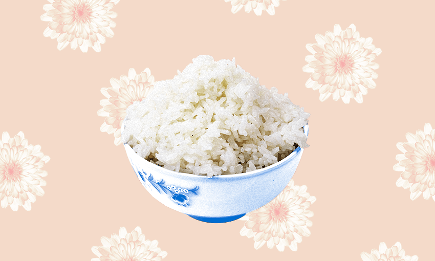 A bowl of white rice on a peach-coloured background
