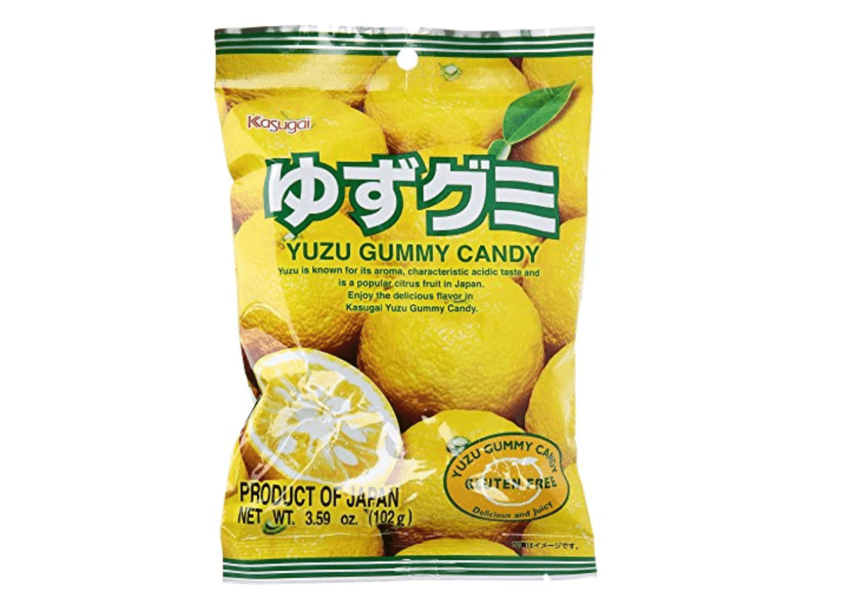 A packet of yuzu gummy candy. The packet is printed with green text on a background of citrus fruit.