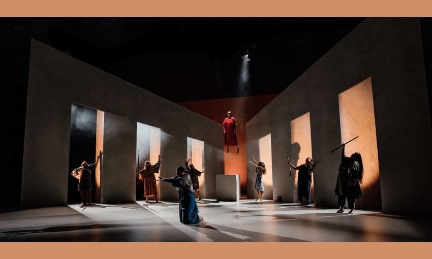 A photograph of a stage set, with actors standing and one appearing to levitate.