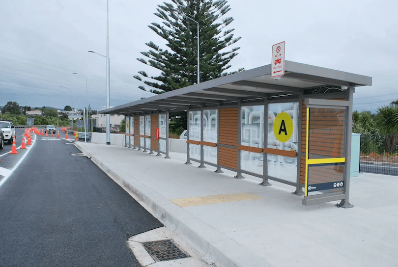 A suburban bus stop featuring leaners instead of seats