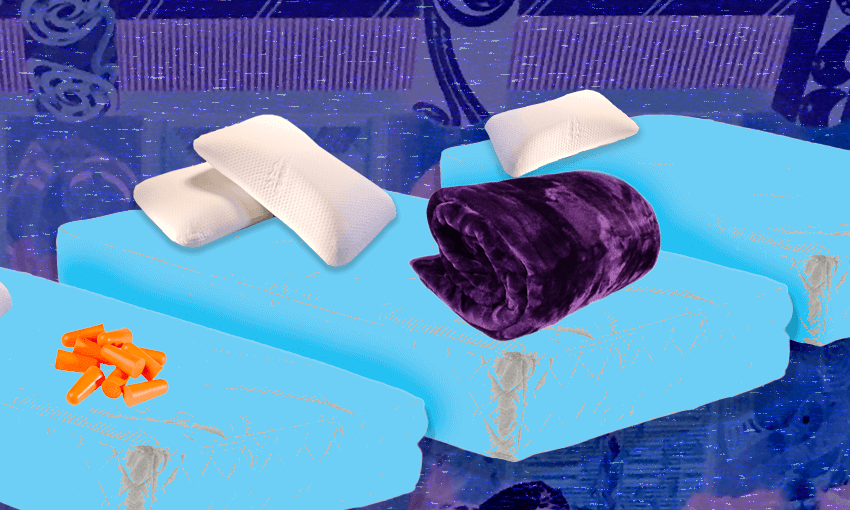 mattresses, pillows, a blanket and earplugs against a backgroun of tukutuku panels