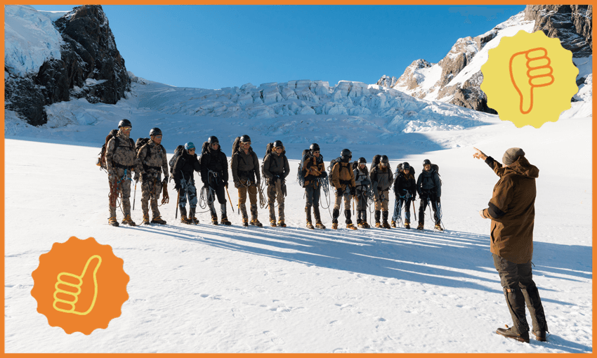 The teams of Tracked stand on the snowy slopes of a mountain