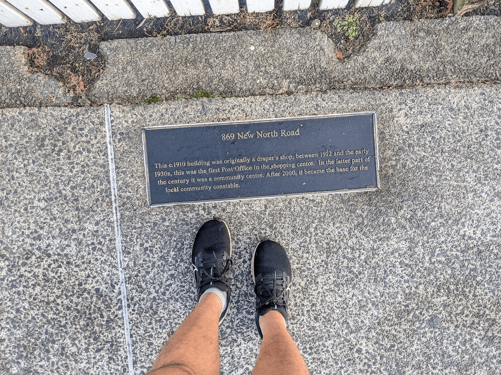 two legs with a plaque in the footpath