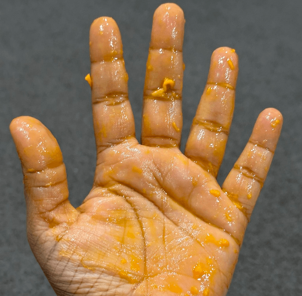 orange stained hands